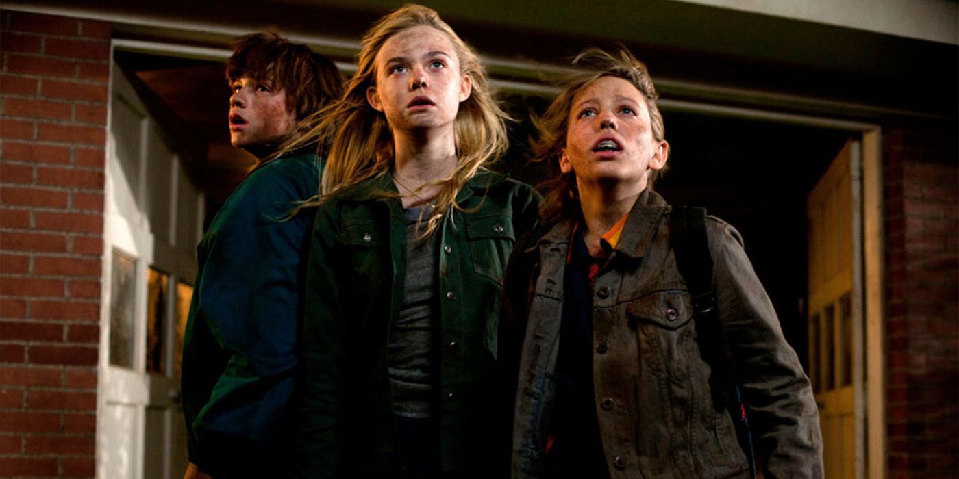 Joe (Joel Courtney), Alice (Elle Fanning), and Cary (Ryan Lee) watch the destruction around them in &lsquo;Super 8&rsquo;