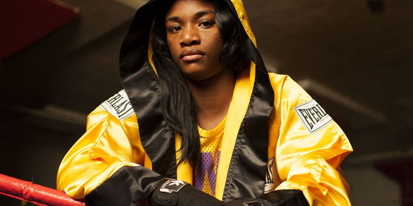 Boxer Claressa Shields in the boxing ring in her gold robe in the documentary T-Rex: Her Fight for Gold