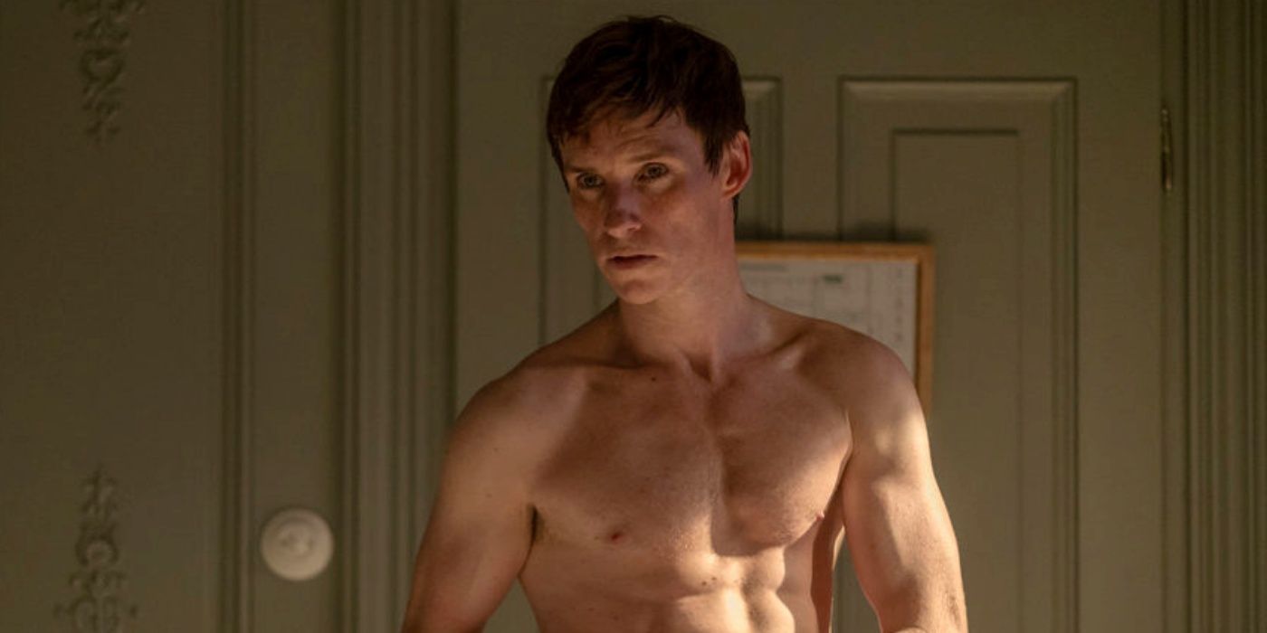 Eddie Redmayne as The Jackal shirtless and looking angry in The Day of the Jackal.