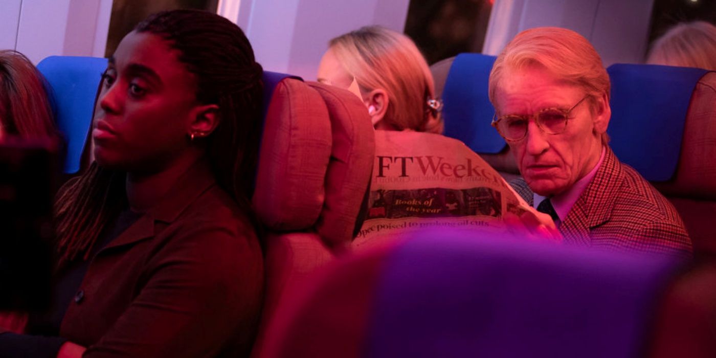 Lashana Lynch as Bianca on an airplane sitting in front of Eddie Redmayne as The Jackal in Day of the Jackal