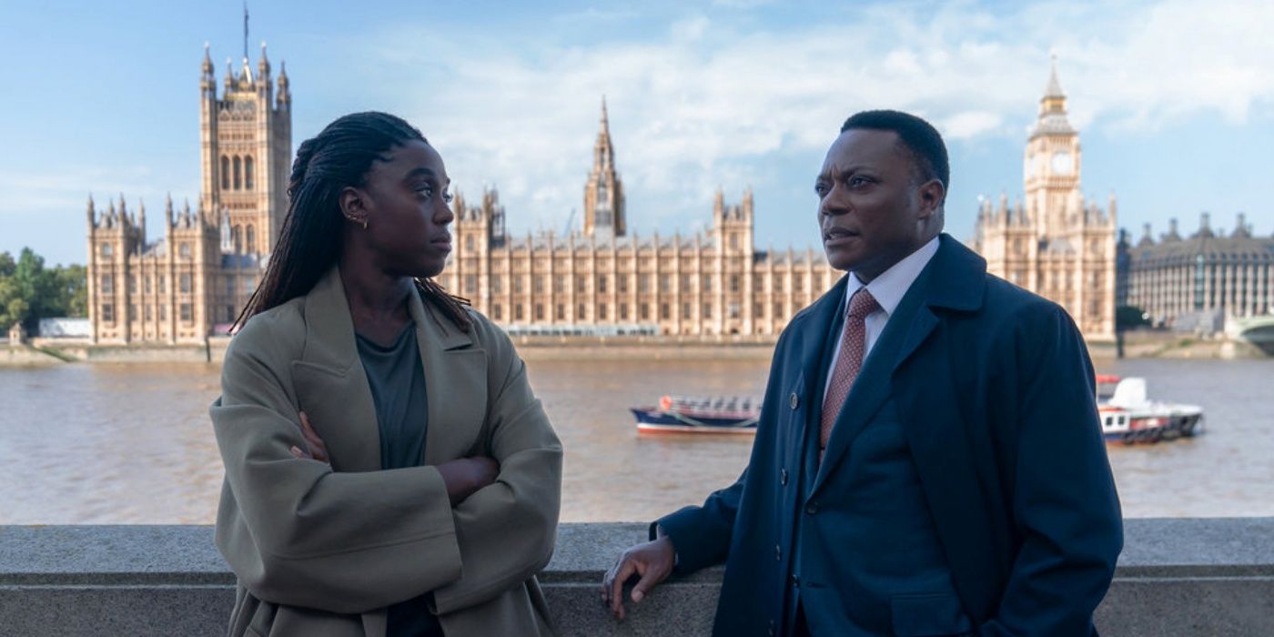 Lashana Lynch as Bianca Pullman leaning against a wall outside with Chukwudi Iwuji in The Day of the Jackal