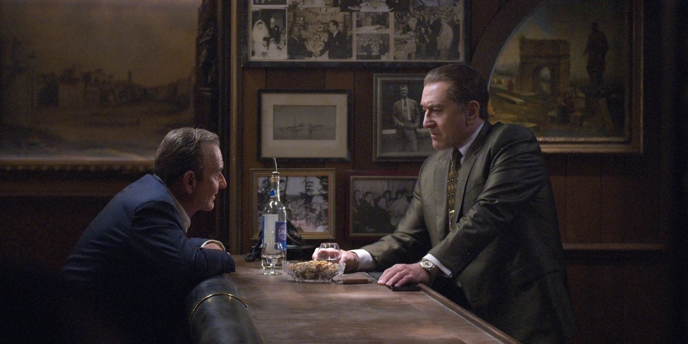 Frank Sheeran (Robert De Niro) and Russell Buffalino (Joe Pesci) sitting across from each other at a bar in "The Irishman"