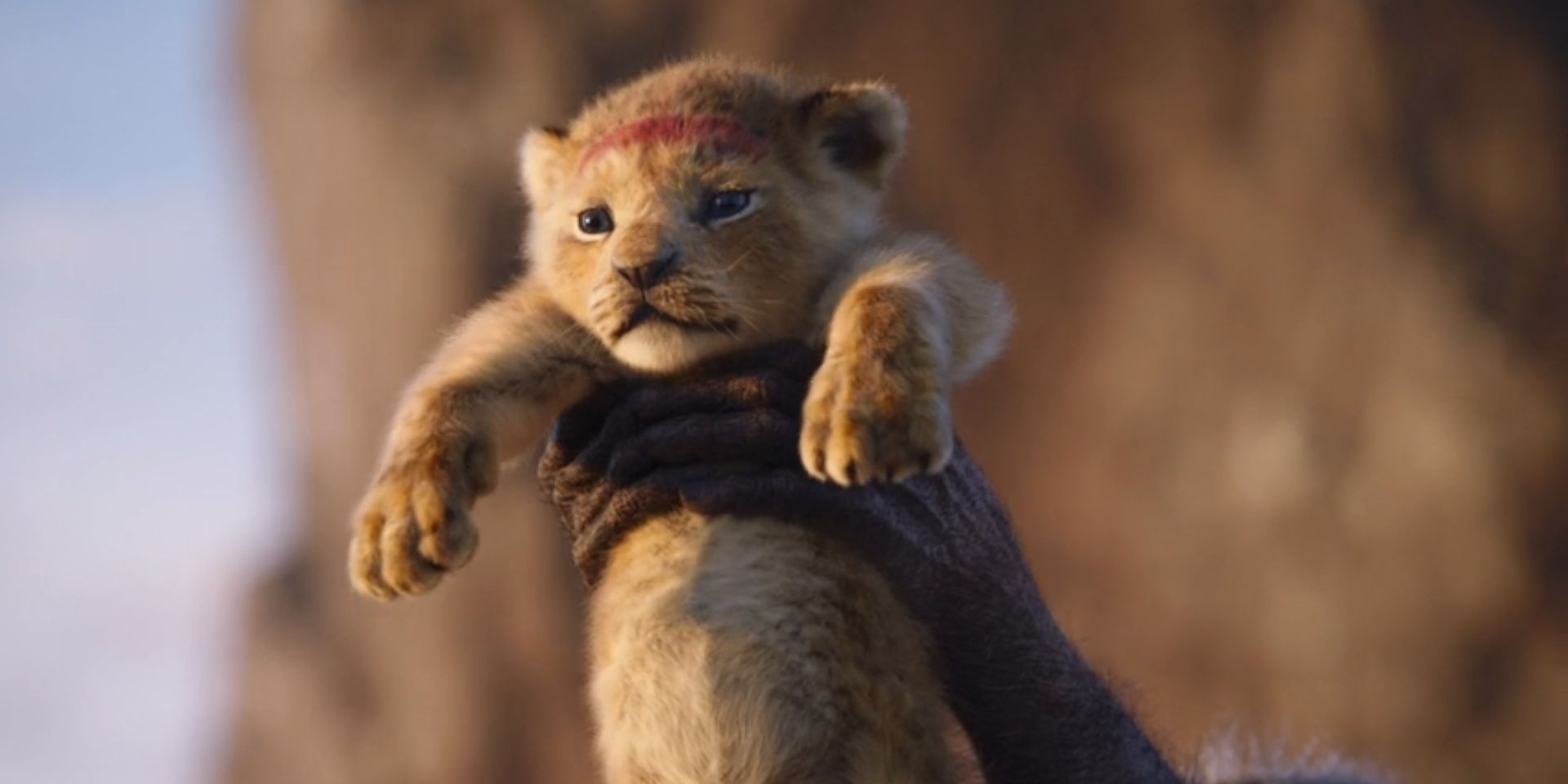 Baby Simba is lifted by Rafiki, voiced by John Kani, in 'The Lion King'.