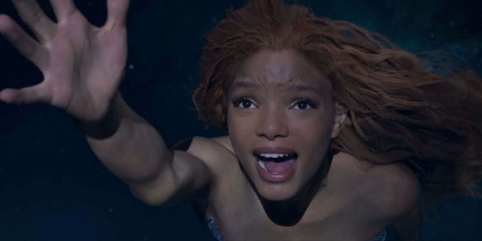 Ariel, played by Halle Bailey, reaches out her hand while swimming upwards in 'The Little Mermaid'.