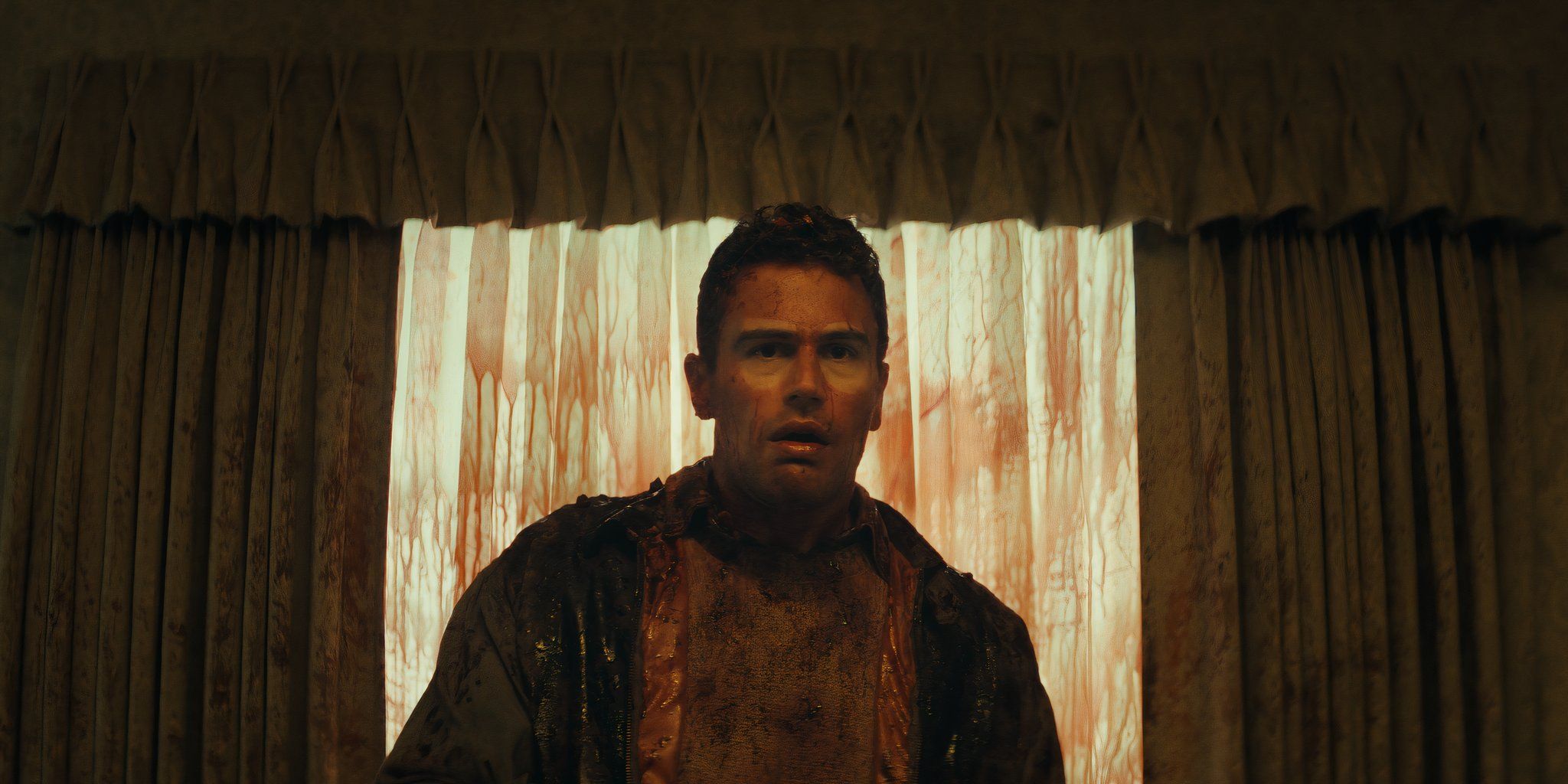 Theo James covered in blood in a scene from The Monkey.