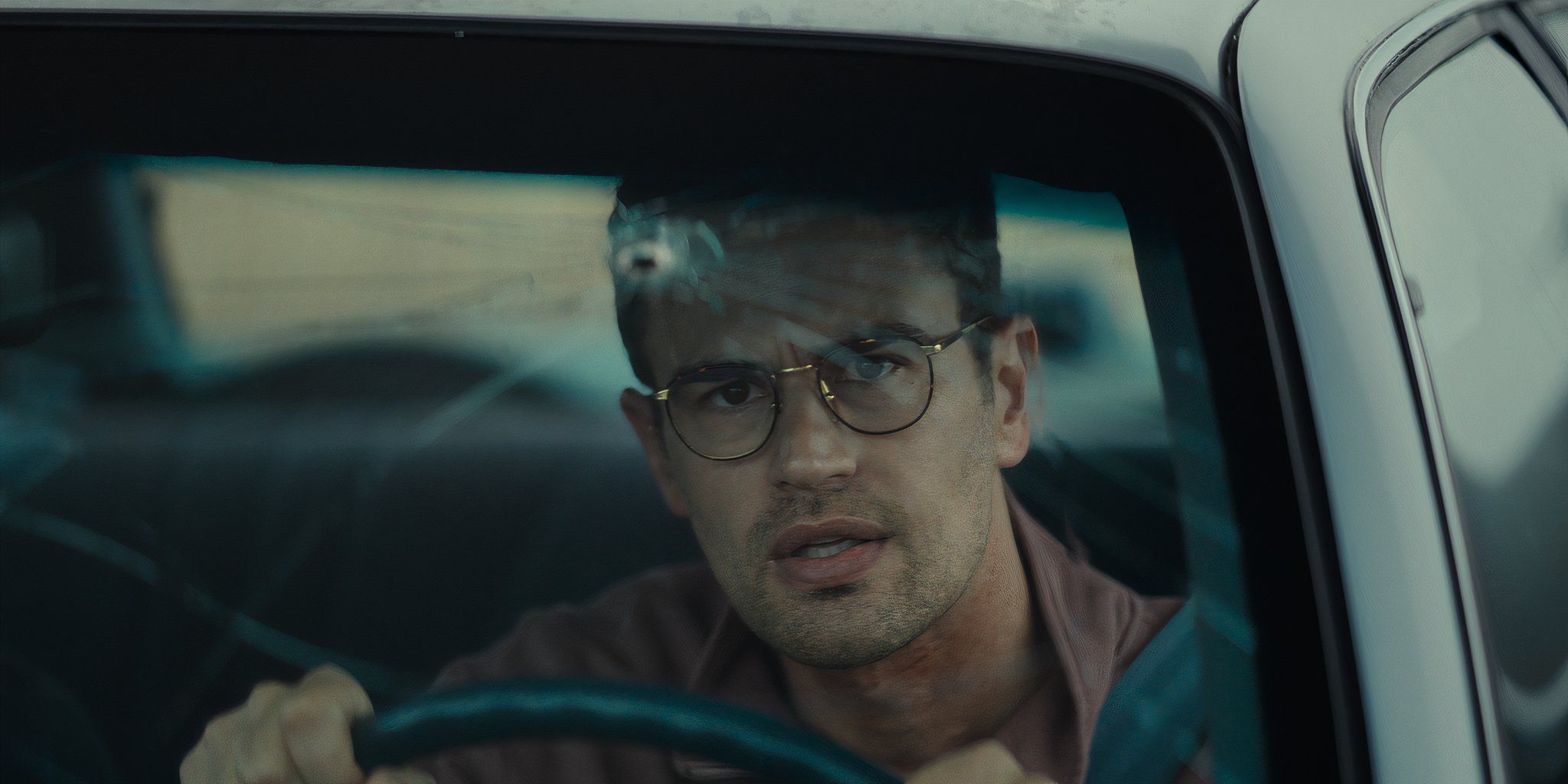 Theo James staring out the broken car window in?Osgood Perkins' The Monkey.