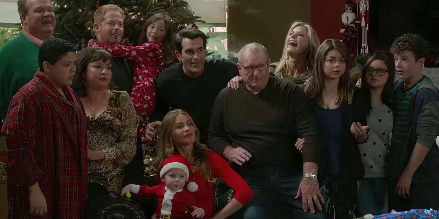 The entire family posing in front of the Christmas tree in Modern Family.