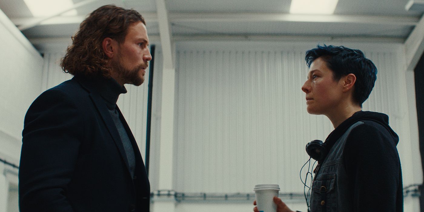 Leo Suter and Emma D'Arcy staring each other down in The Talent