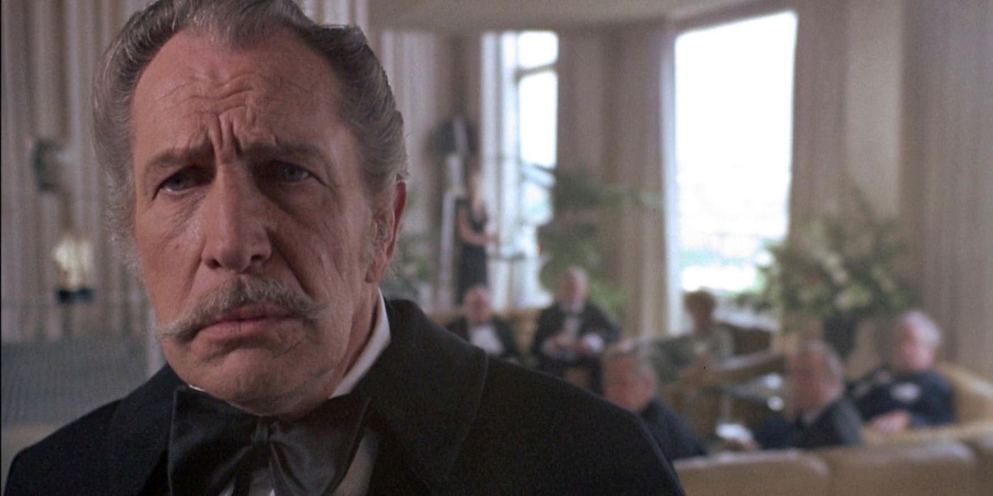 A close up of Edward Lionheart (Vincent Price) standing on the far left of the frame and looking ashamed, with a group of theatre critics sitting behind him on the right, in Theatre of Blood