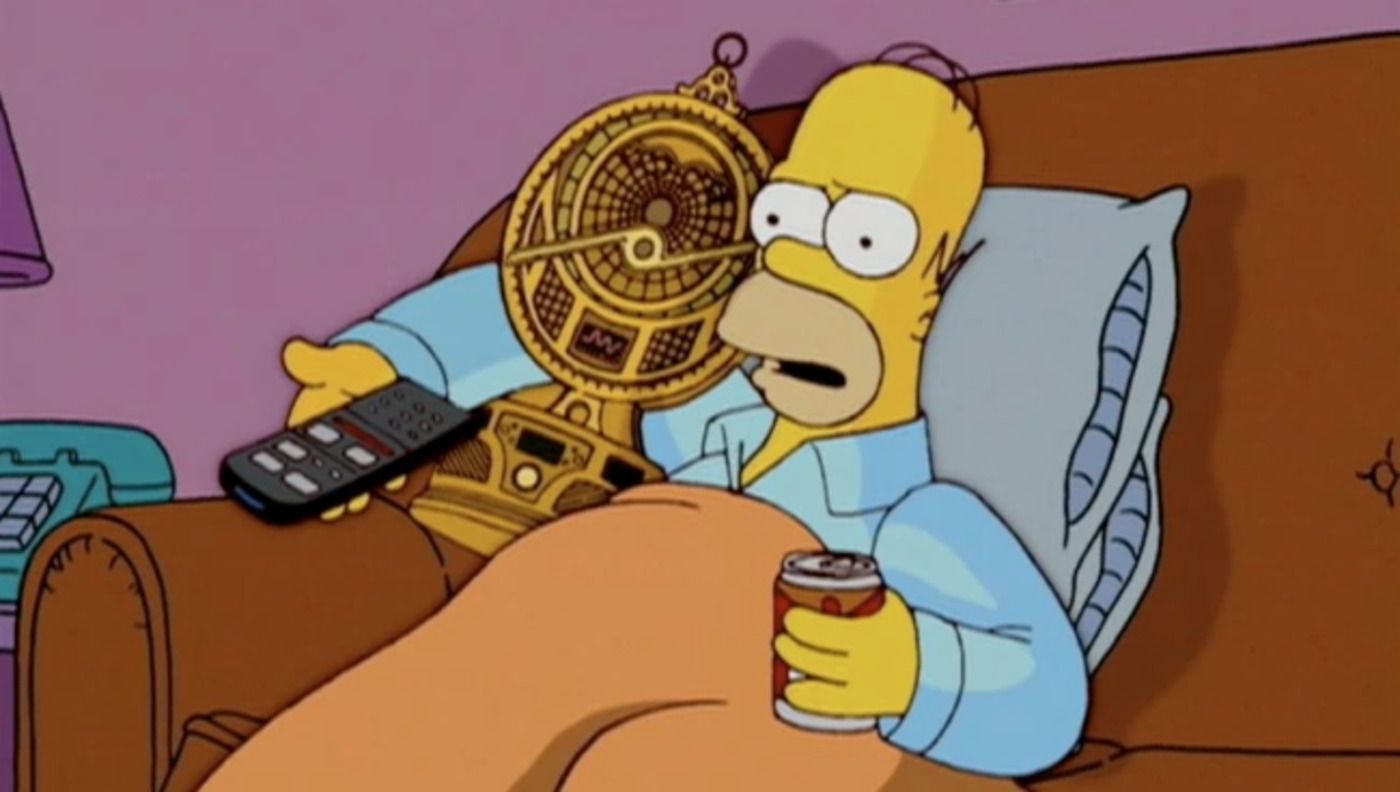 Homer sitting on the couch with his expensive Christmas gift 