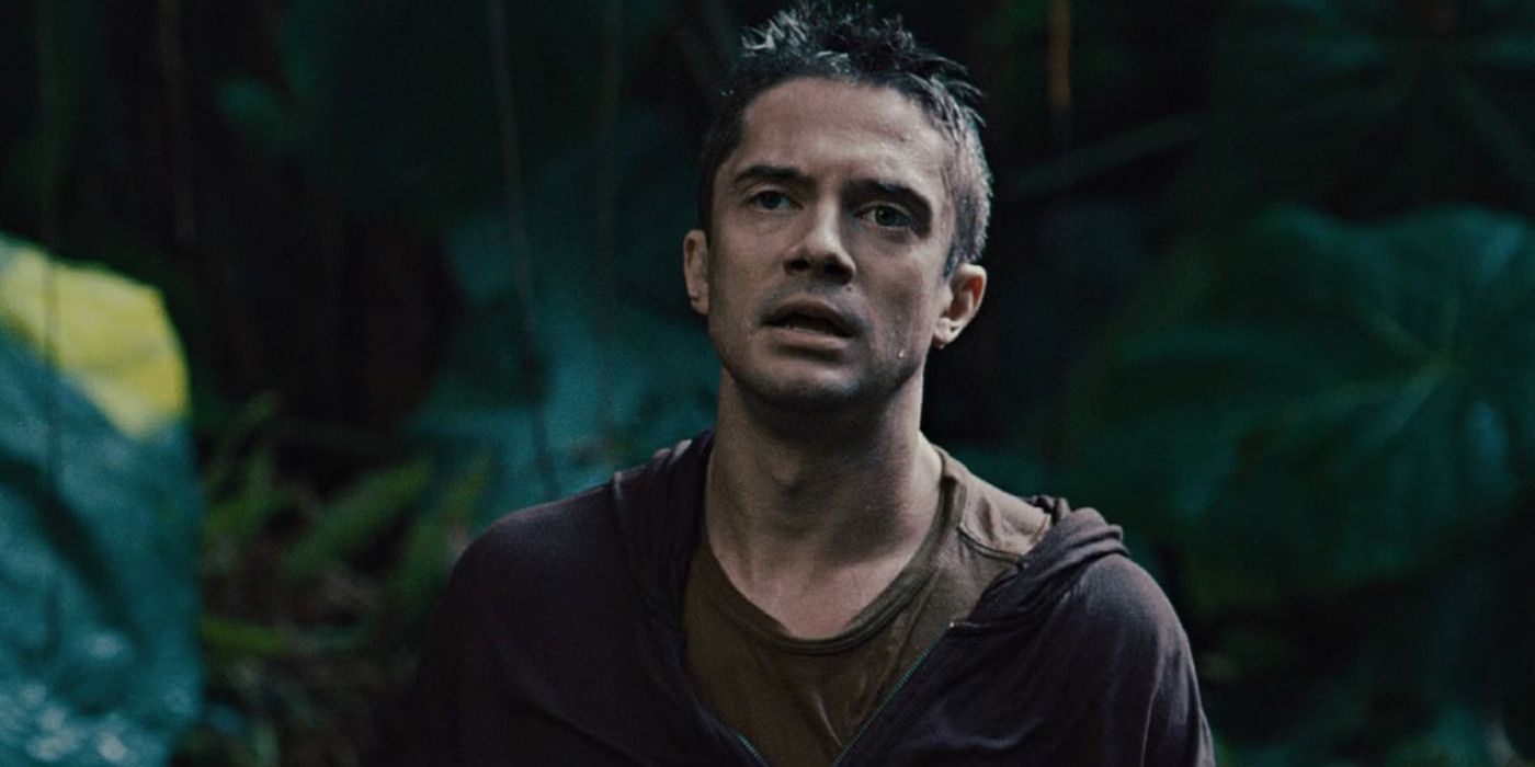 Topher Grace walks in the jungle in Predators.