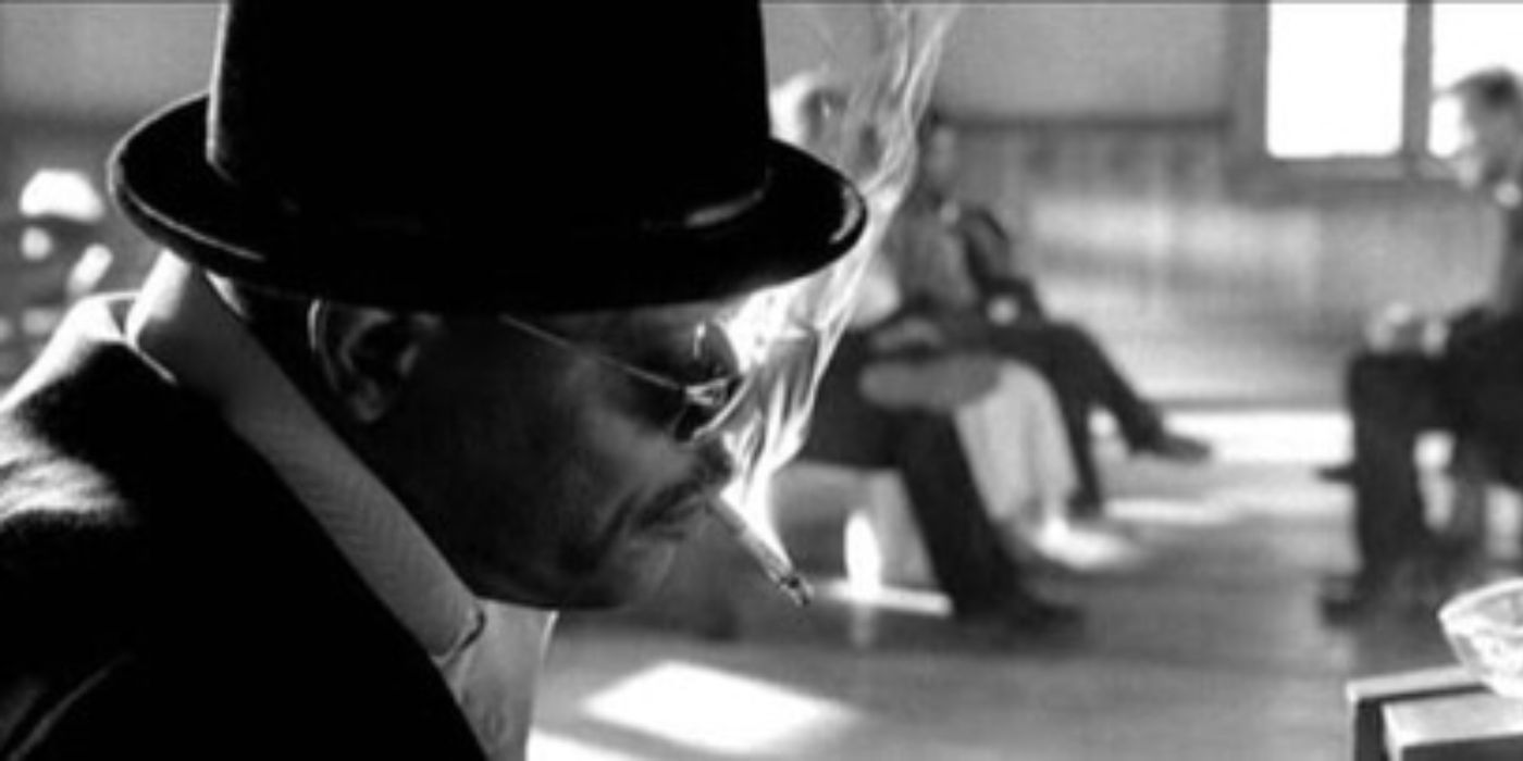 Samuel L. Jackson as Rufus wearing a hat and sunglassed and smoking a cigarette in Kill Bill Vol. 2.