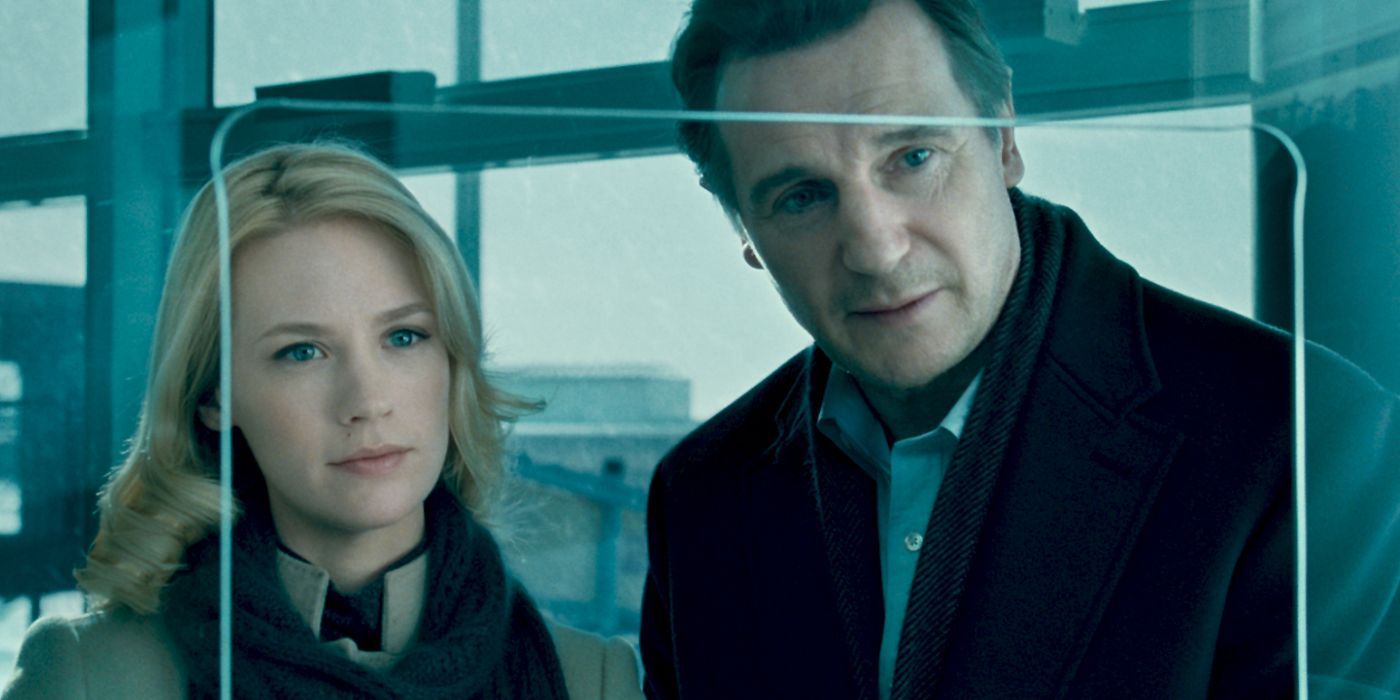Liam Neeson &amp; January Jones looking at someone ahead in Unknown (2011)