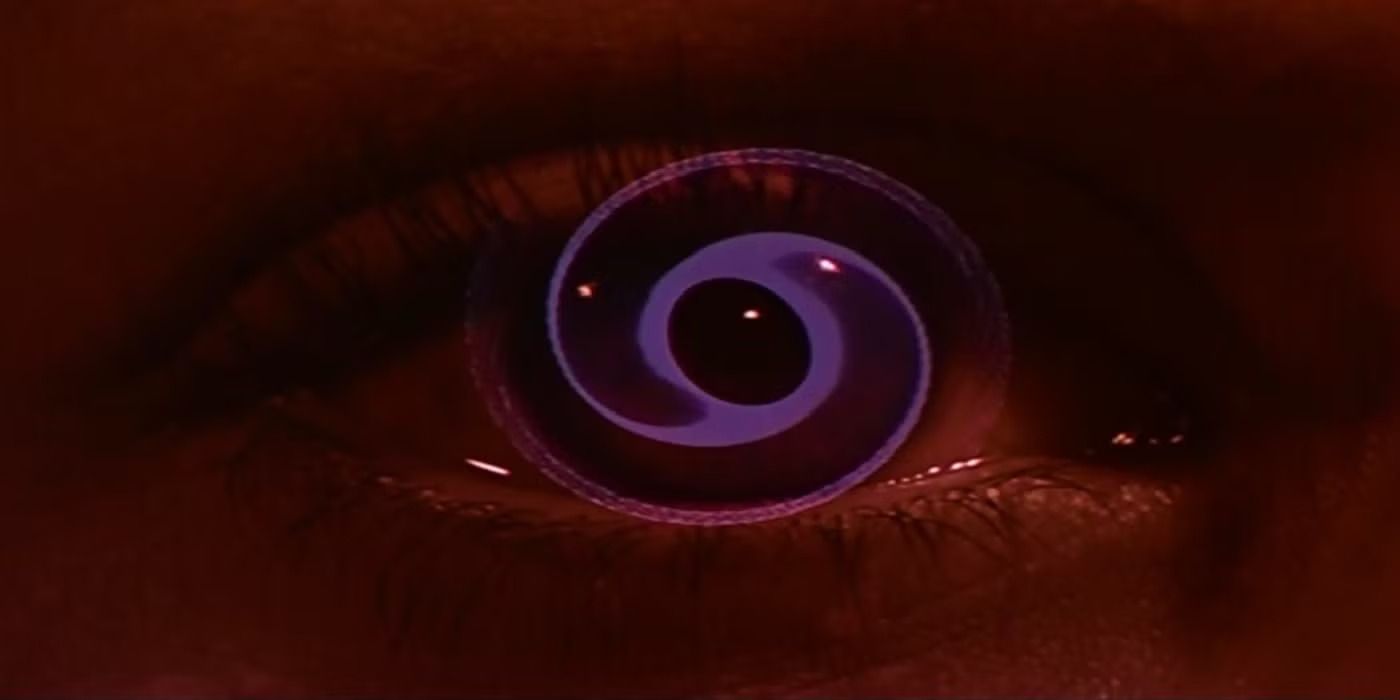 A closeup of an eyeball in fully red lighting with a purple spiral overlaid on top of it in 'Vertigo'