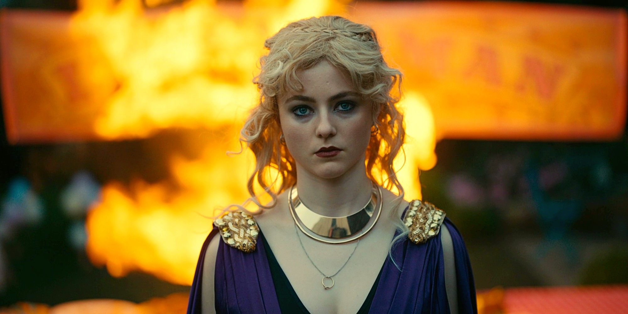 Vivian dressed as Persephone and standing in front of a fire in Totally Completely Fine.