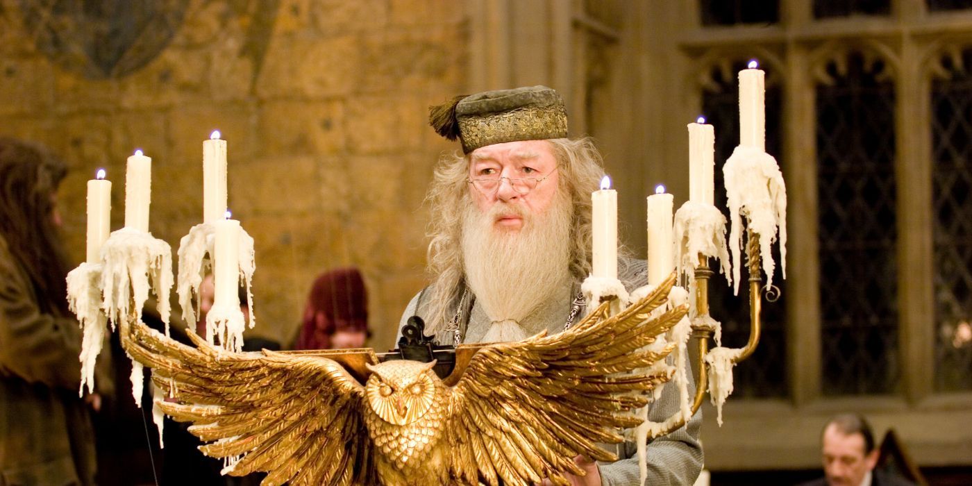Dumbledore stands at an owl-shaped podium with dripping candles in Harry Potter and the Goblet of Fire.