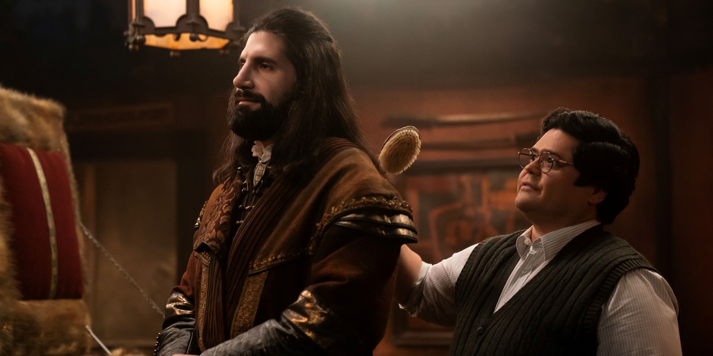 Harvey Guillén as Guillermo standing behind Kayvan Novak as Nandor in What We Do in the Shadows Season 6