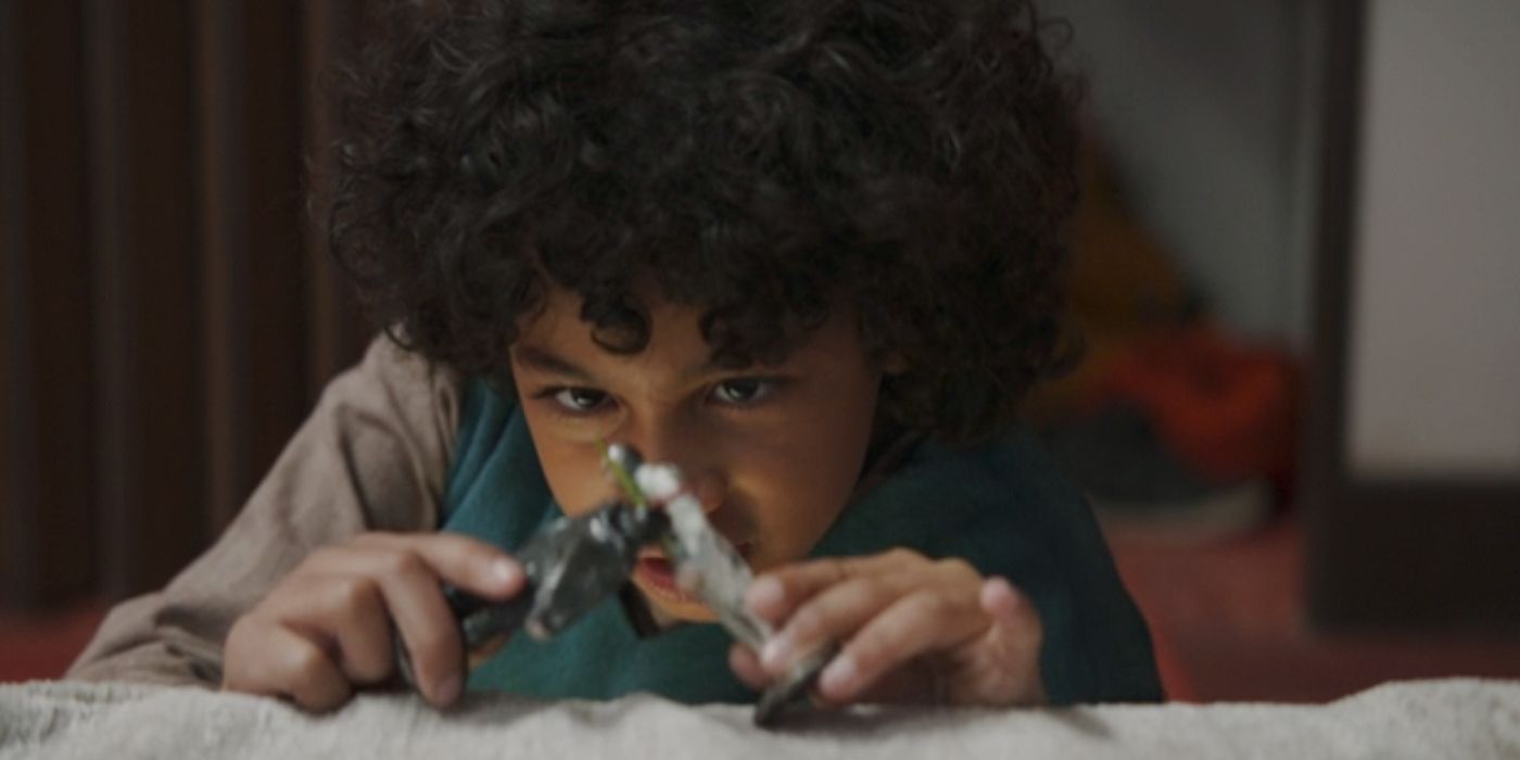 Wim (Ravi Cabot-Conyers) playing with action figures in &lsquo;Star Wars: Skeleton Crew.'