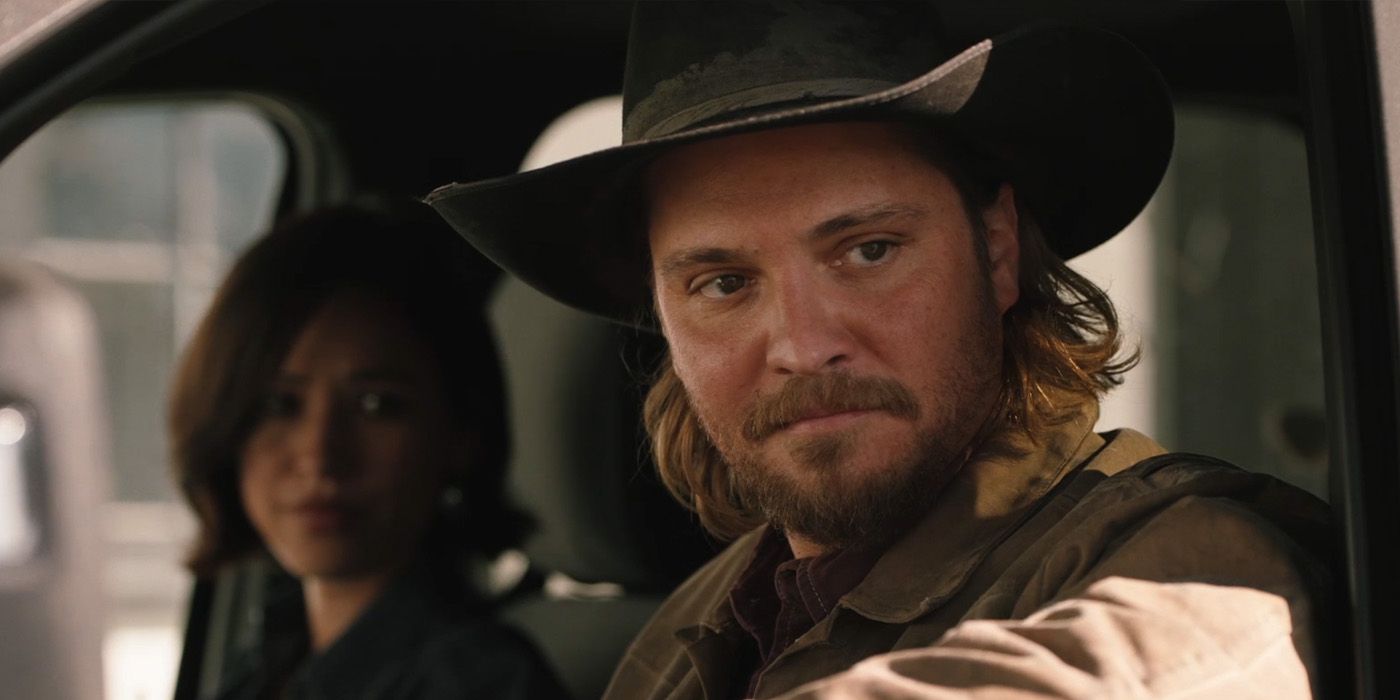 Kayce (Luke Grimes) and Monica Dutton (Kelsey Asbille) sitting in a truck on 'Yellowstone'