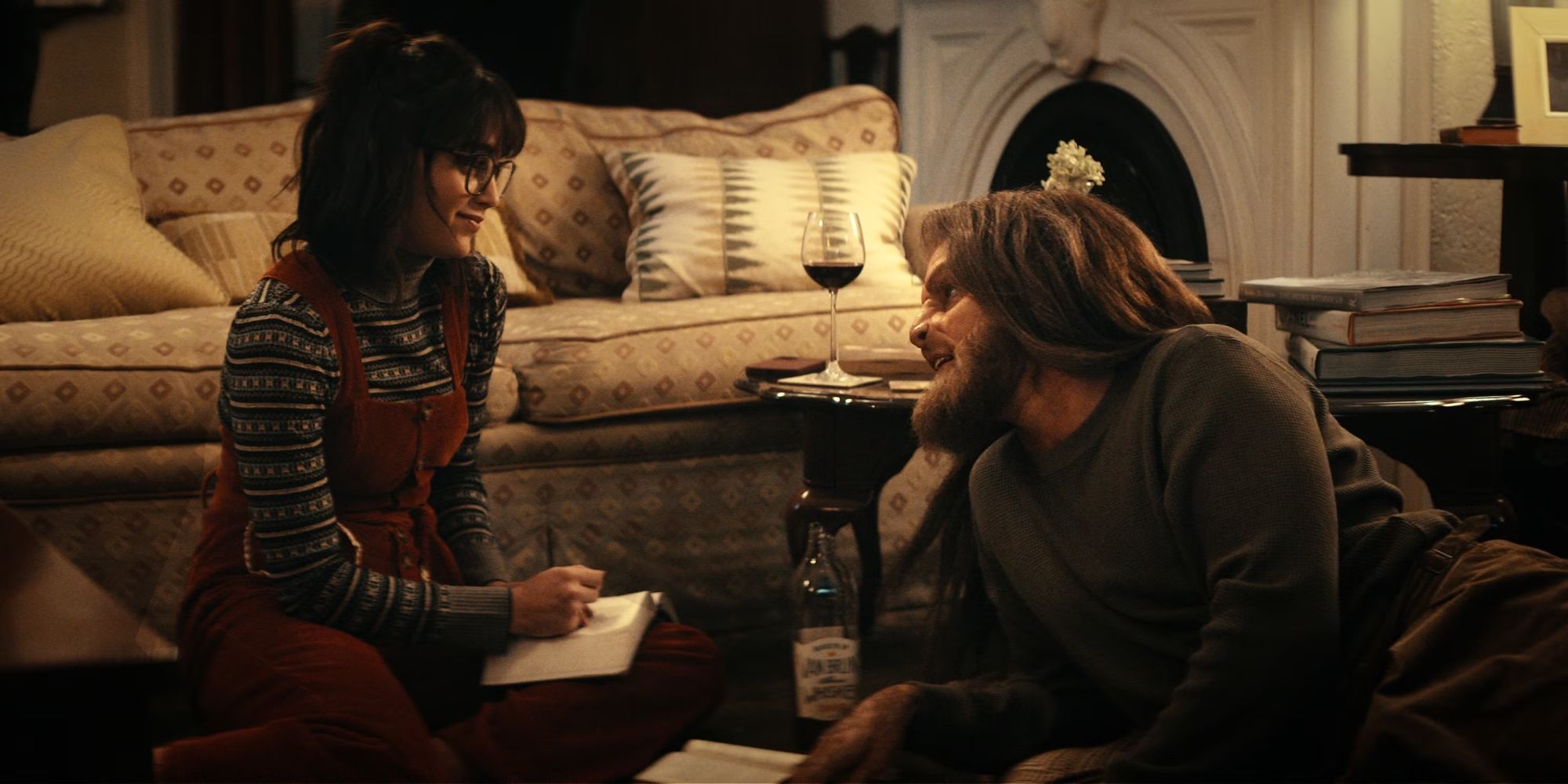 Melissa Barrera sitting on the floor with Tom Dewey as Monster in Your Monster.