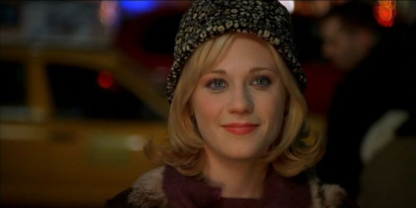 Zooey Deschanel as Jovie wearing a hat with traffic and people in the background in Elf.