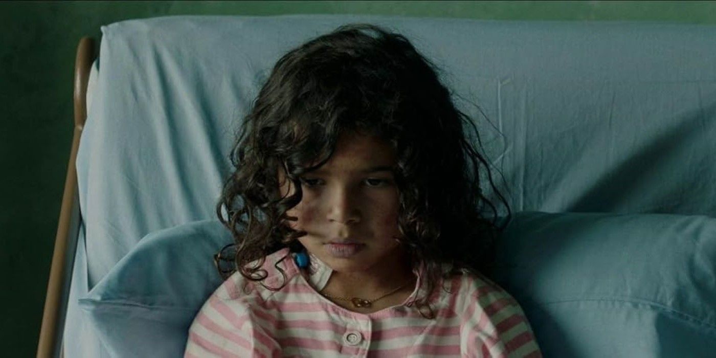 A.J. Lister as Lila sitting up in bed in Birth/Rebirth