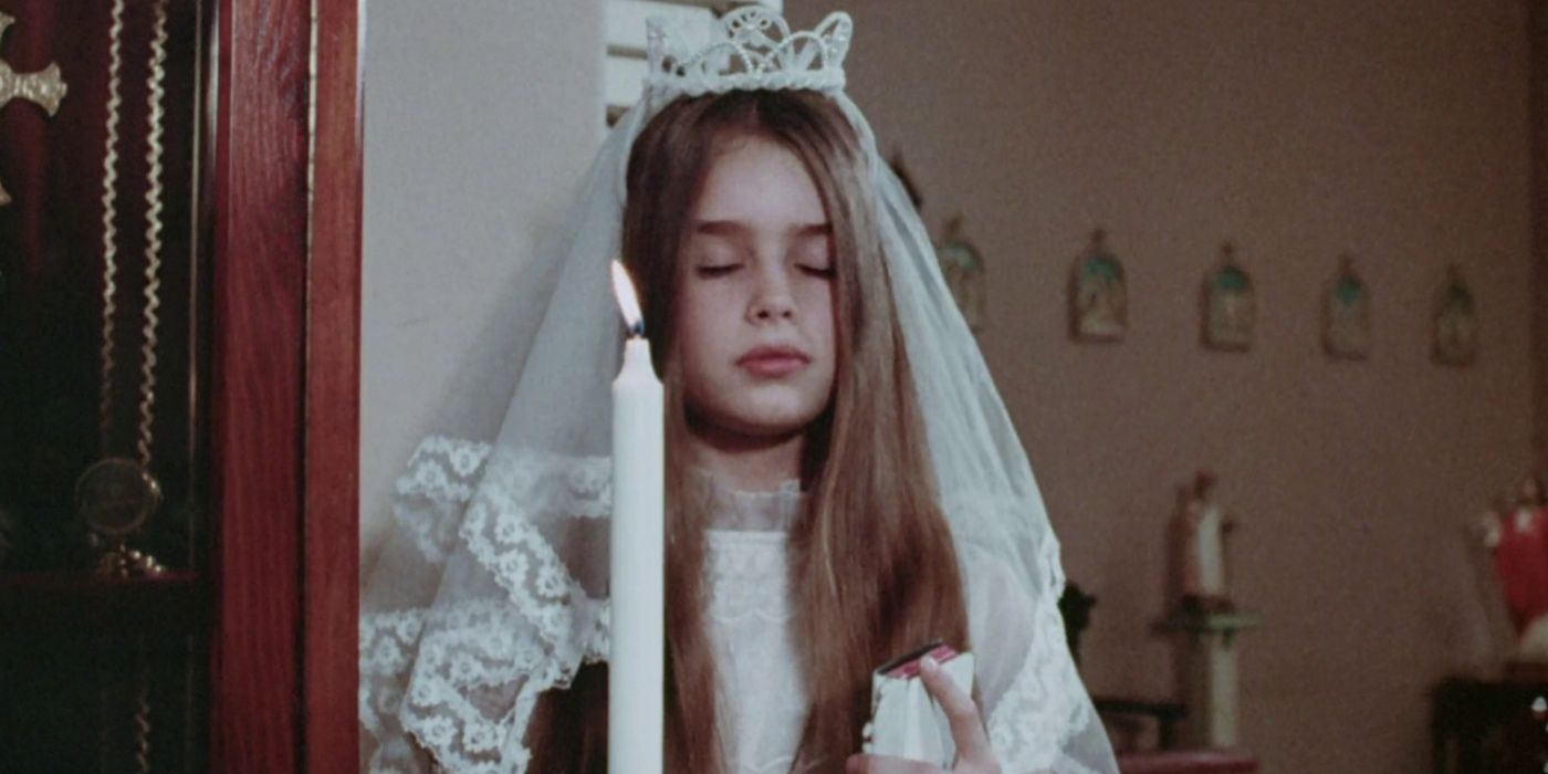 Brooke Shields, as Karen Spages, in Alice, Sweet Alice standing in front of a lit candle and wearing a white veil and dress.
