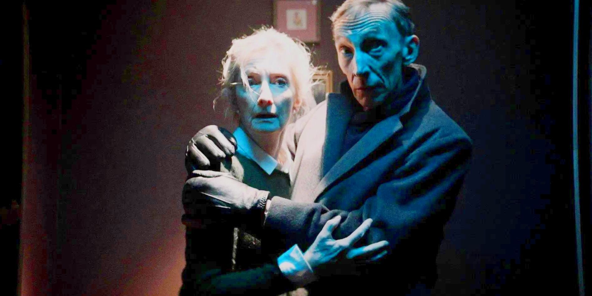 Audrey and Henry, played by actors Sheila McCarthy and Julian Richings, clutch each other fearfully in a dark room in Anything For Jackson.