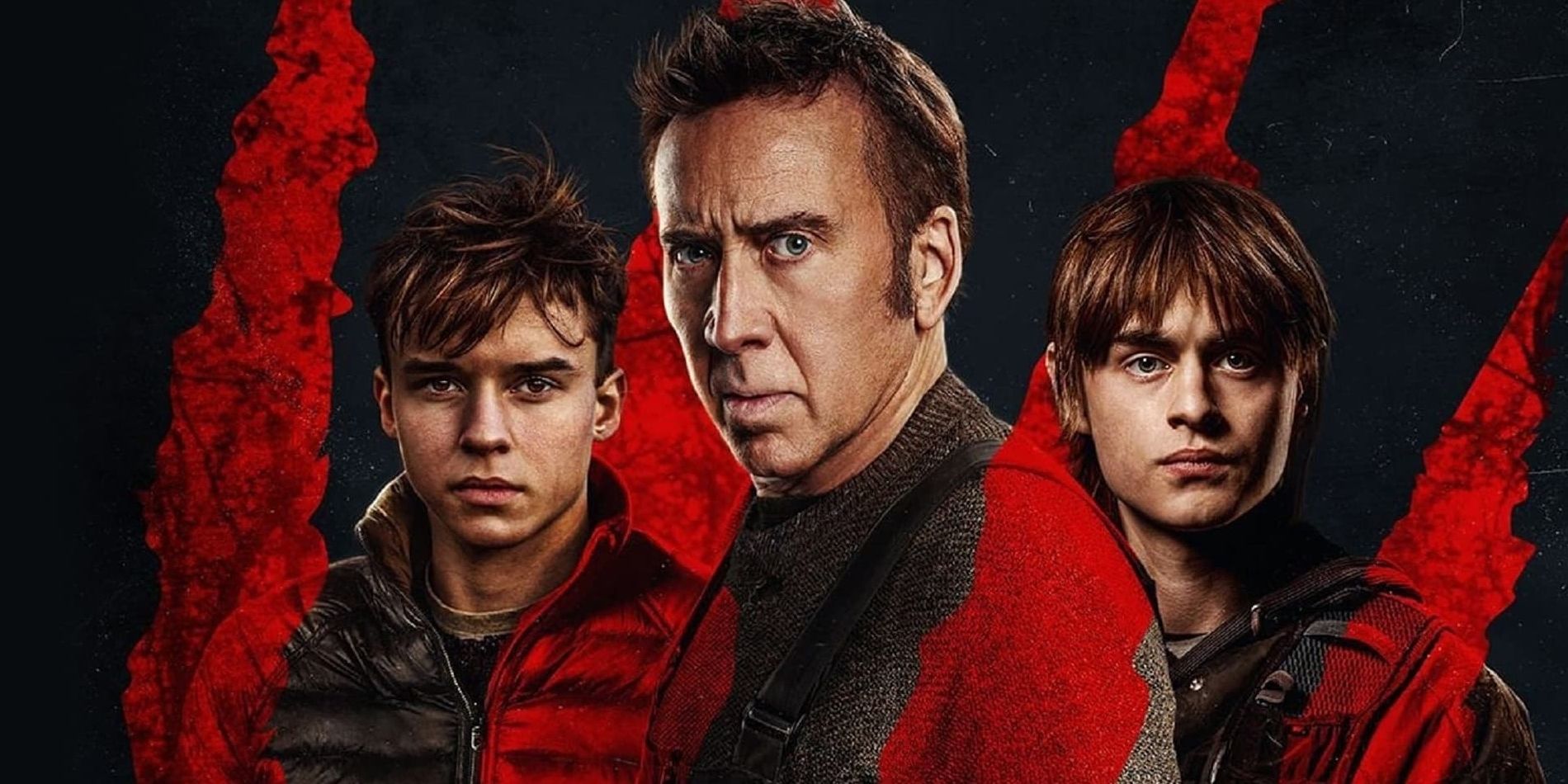 Paul, played by actor Nicolas Cage, with Joseph and Thomas, played by actors Jaeden Martell and Maxwell Jenkins, beside him, with red claw marks across the picture.