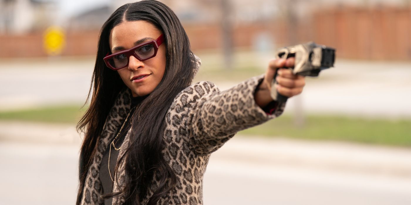 Ariana DeBose as Rose Carlisle wearing sunglasses and a leopard print jacket, holding a taser, in Love Hurts