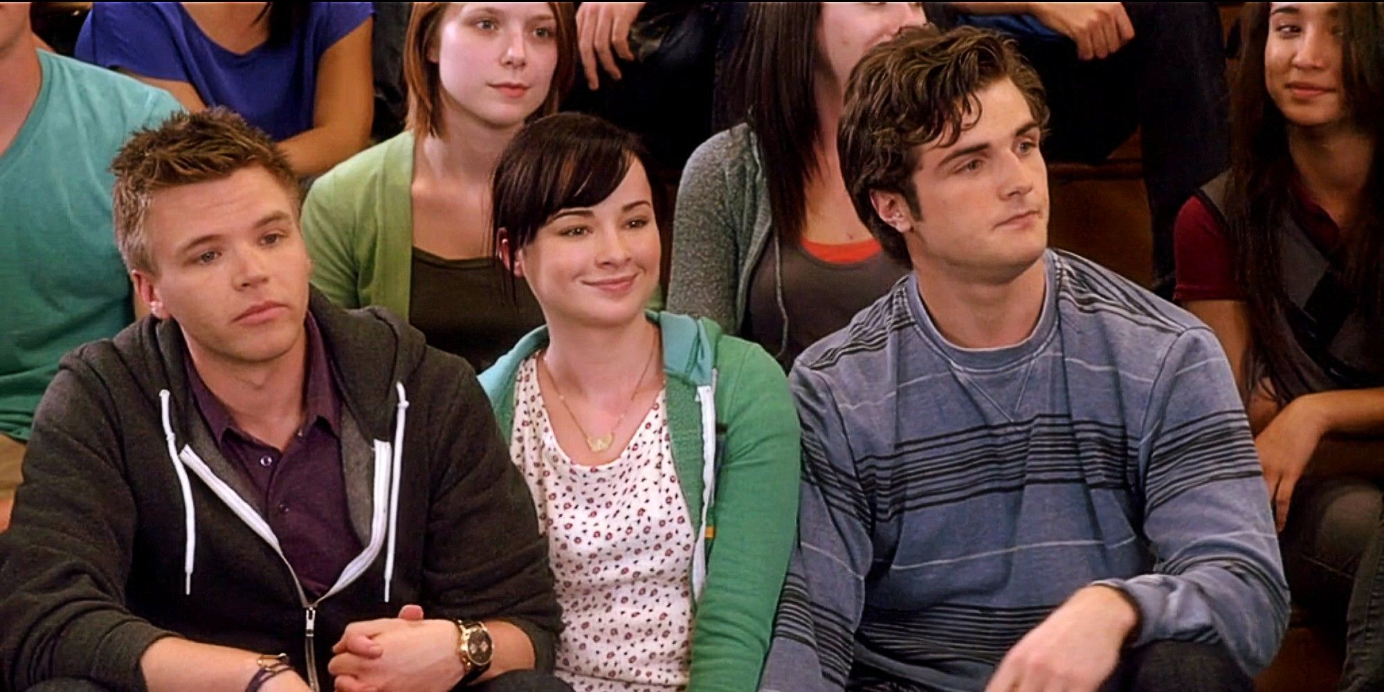 Jake Rosati, Jenna Hamilton, and Matty McKibben sitting at a pep rally together in Awkward