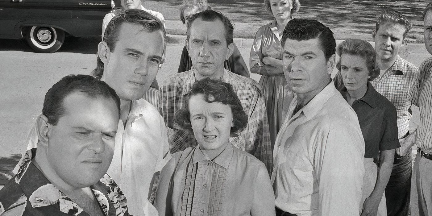 Neighbors stand around, gossiping and stare at the viewer in The Monsters Are Due On Maple Street in The Twilight Zone. 