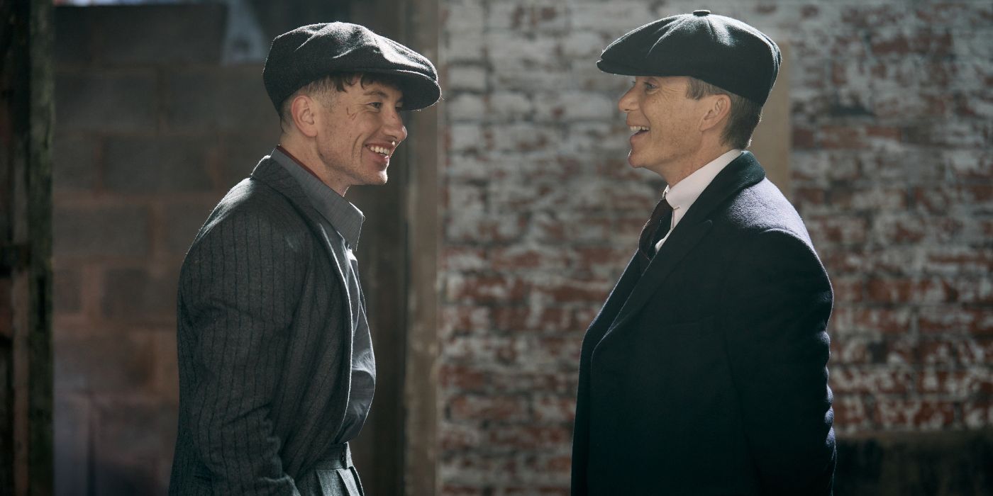 Barry Keoghan and Cillian Murphy smiling while facing each other on the set of the Peaky Blinders movie, The Immortal Man.