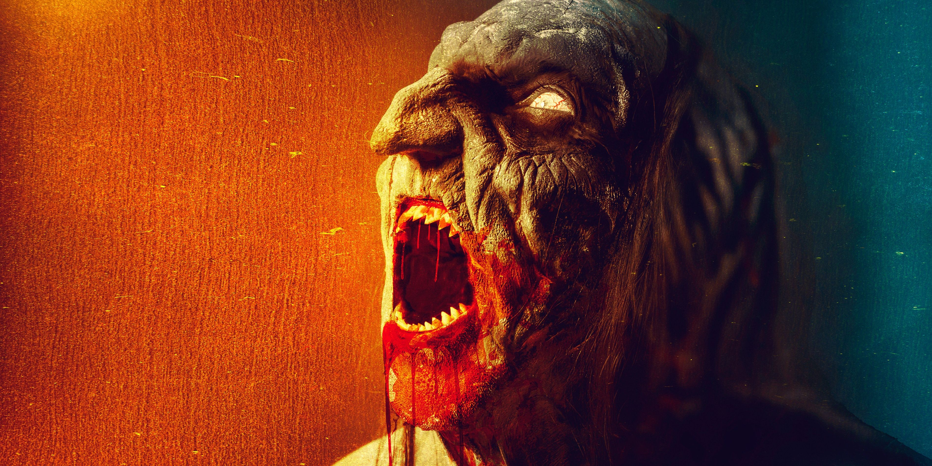 A hideous creature with glowing eyes and sharp fangs dripping with blood screams on the poster for Beezel.