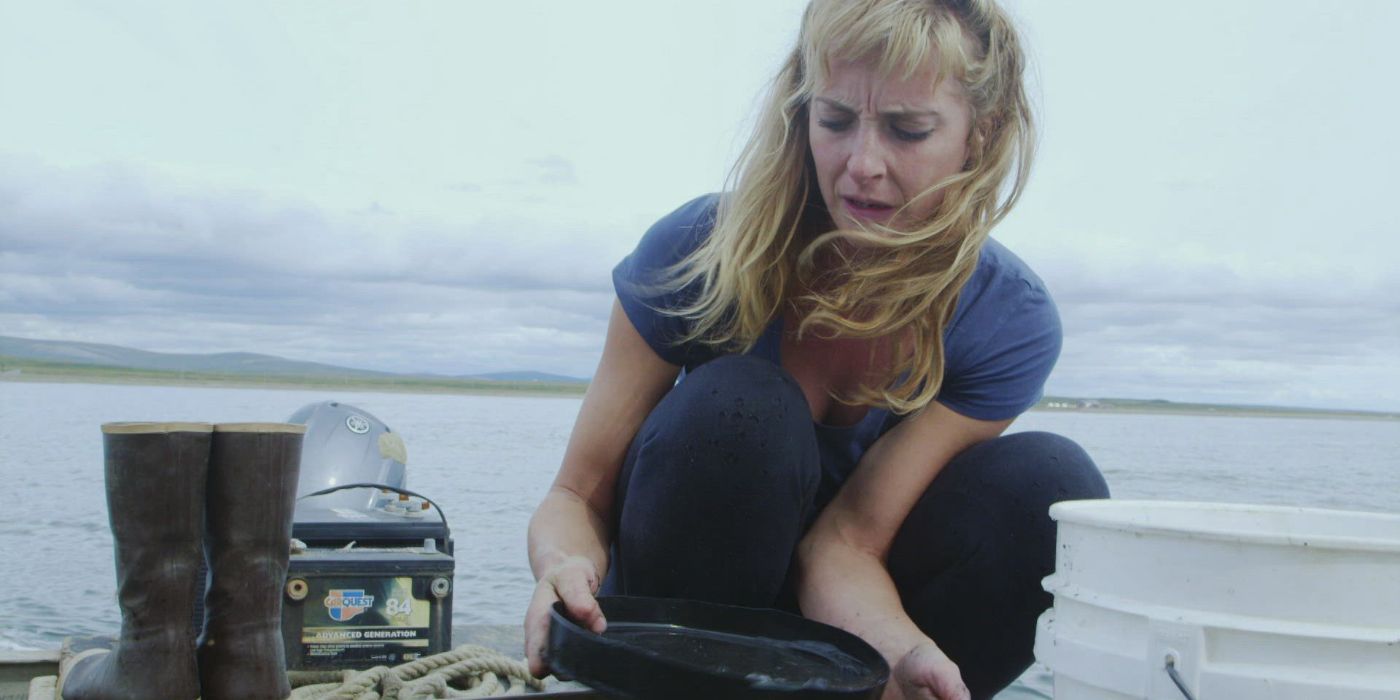 A woman panning for gold in the reality series Being Sea Gold.