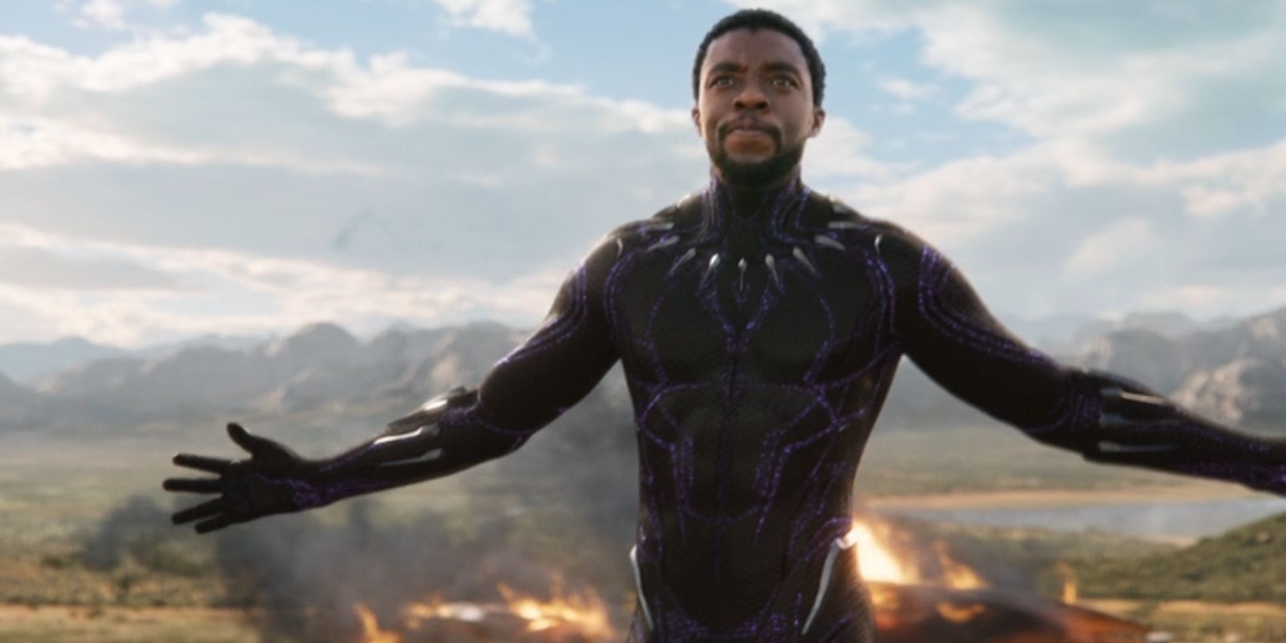 T&rsquo;Challa, played by Chadwick Boseman holds his arms out while in the Black Panther suit in &lsquo;Black Panther&rsquo;.