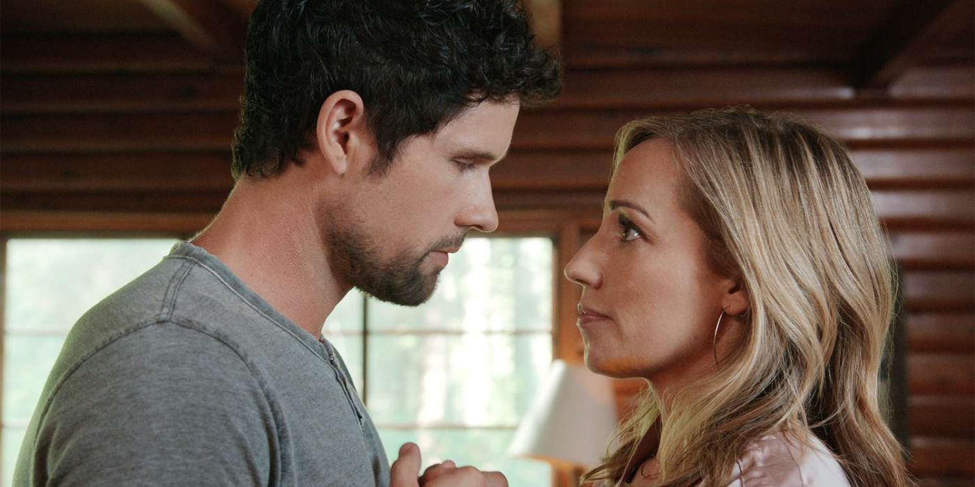 Brady and Brie talking and holding hands inside a wooden home in 'Virgin River' 