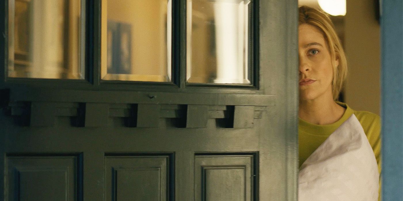 Jo (Joanna Leeds) peeking around a green door in Bulldozer