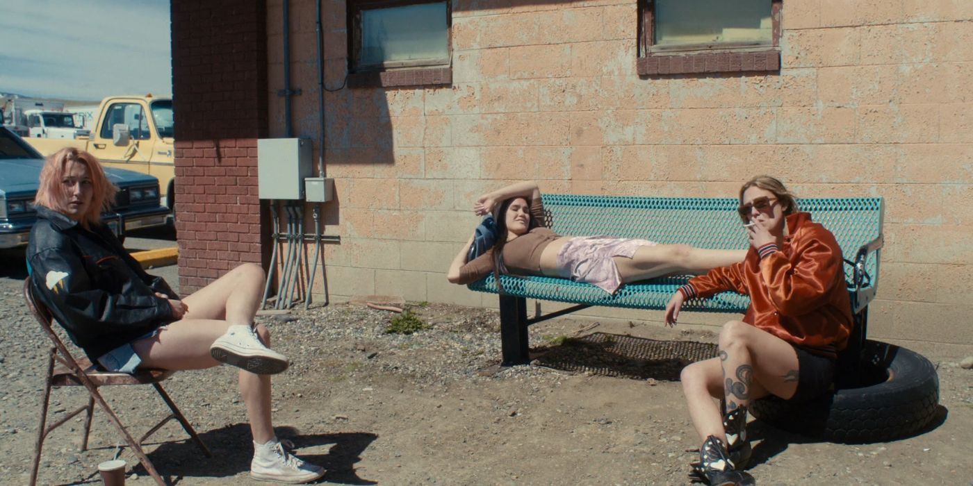 Riley, Liv, and Sadie sit outside the truck stop bathroom taking a break from work.