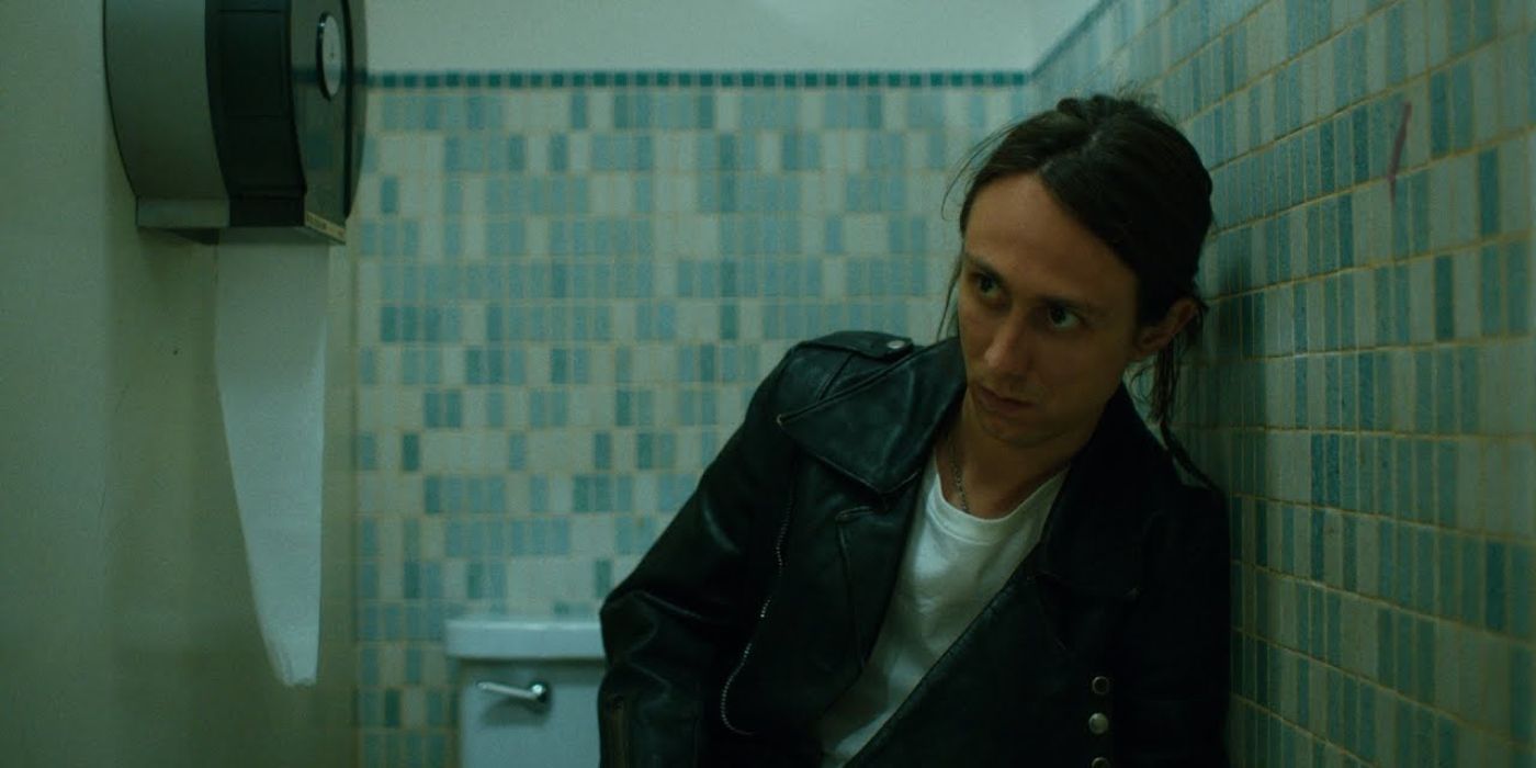 Levi, portrayed by Owen Campbell, hears footsteps outside the bathroom stall.