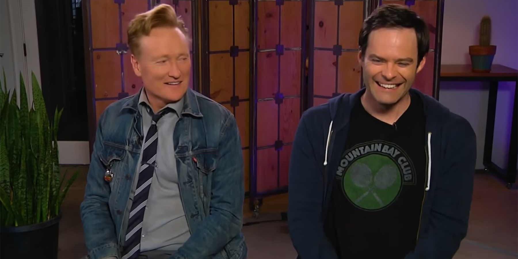 Conan O'Brien looks at Bill Hader as they both laugh in the Clueless Gamer segment on Conan.