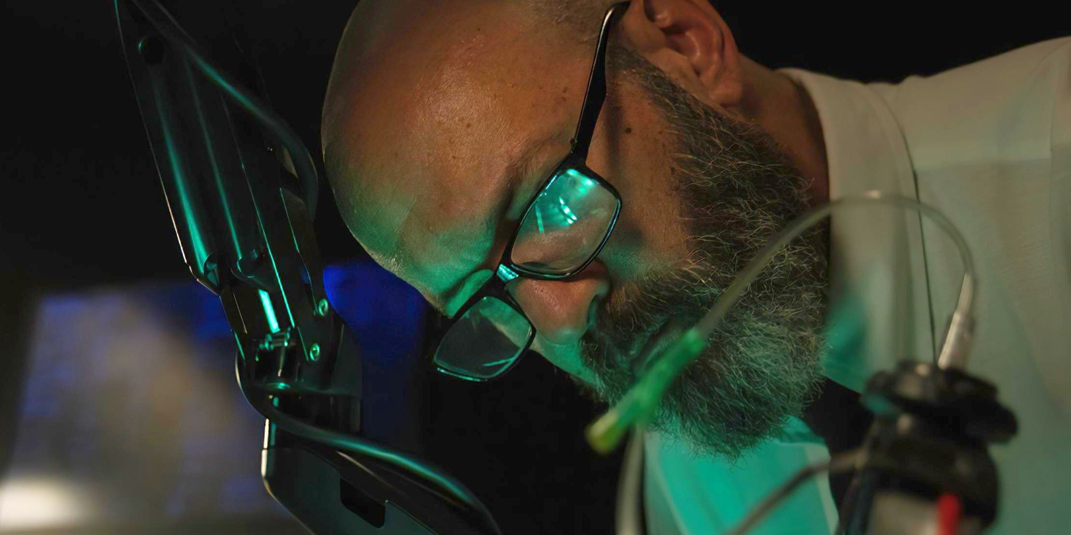 Dr. Caul, played by actor Geoffrey Cantor, leans over his work in a lab in Creep Box.