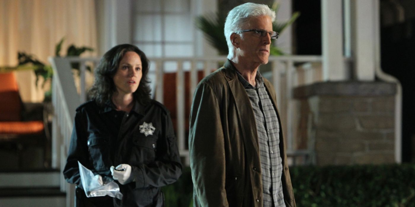 Jorja Fox and Ted Danson stand outside a house at night in CSI.