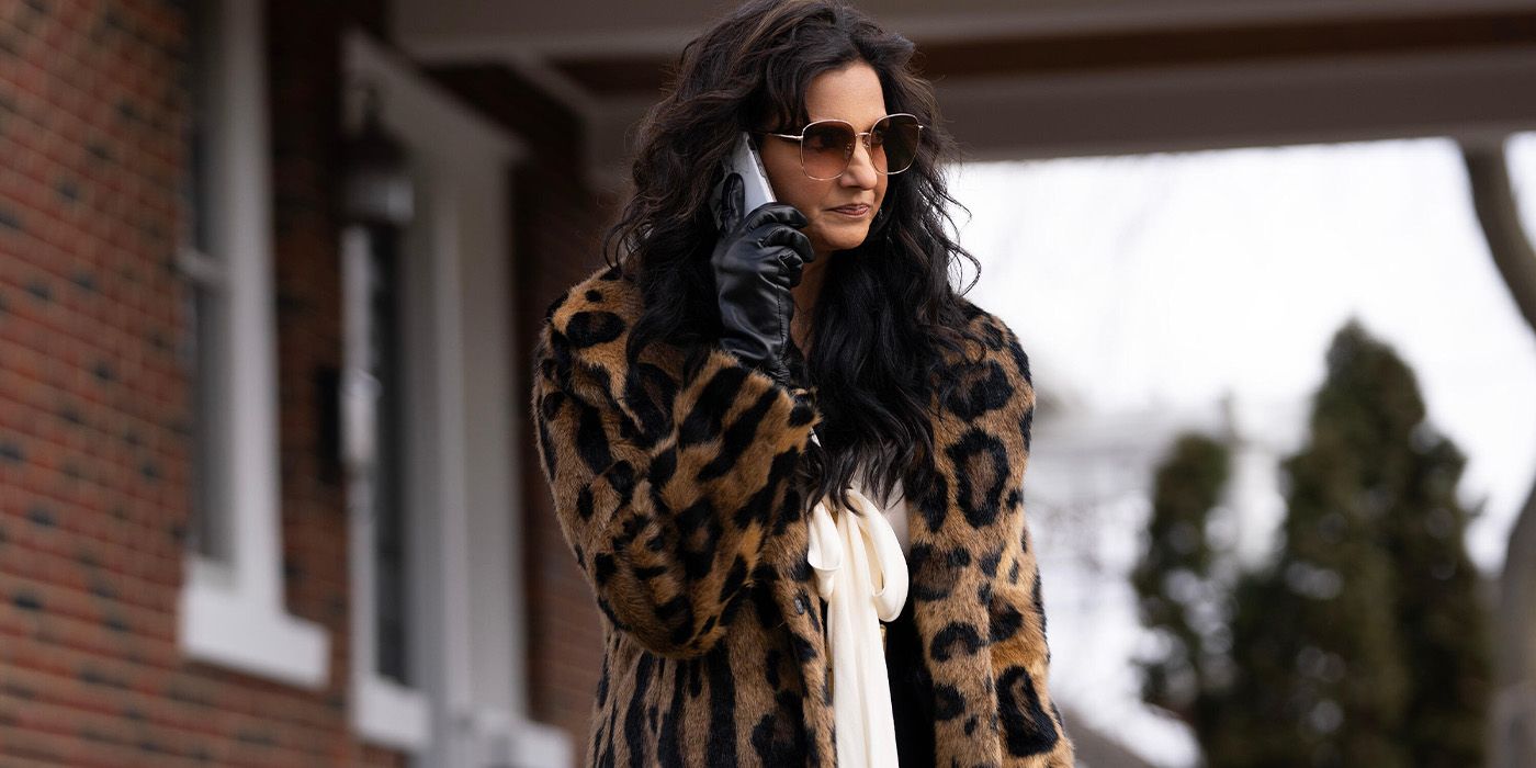 Lucky (Poorna Jagannathan) in a leopard print coat on the phone in Deli Boys
