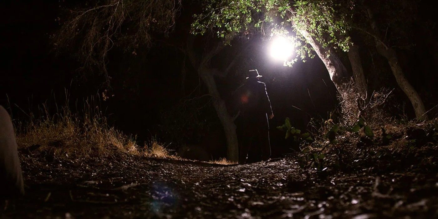 A man stands in the dark woods in &lsquo;Digging Up the Marrow&rsquo;
