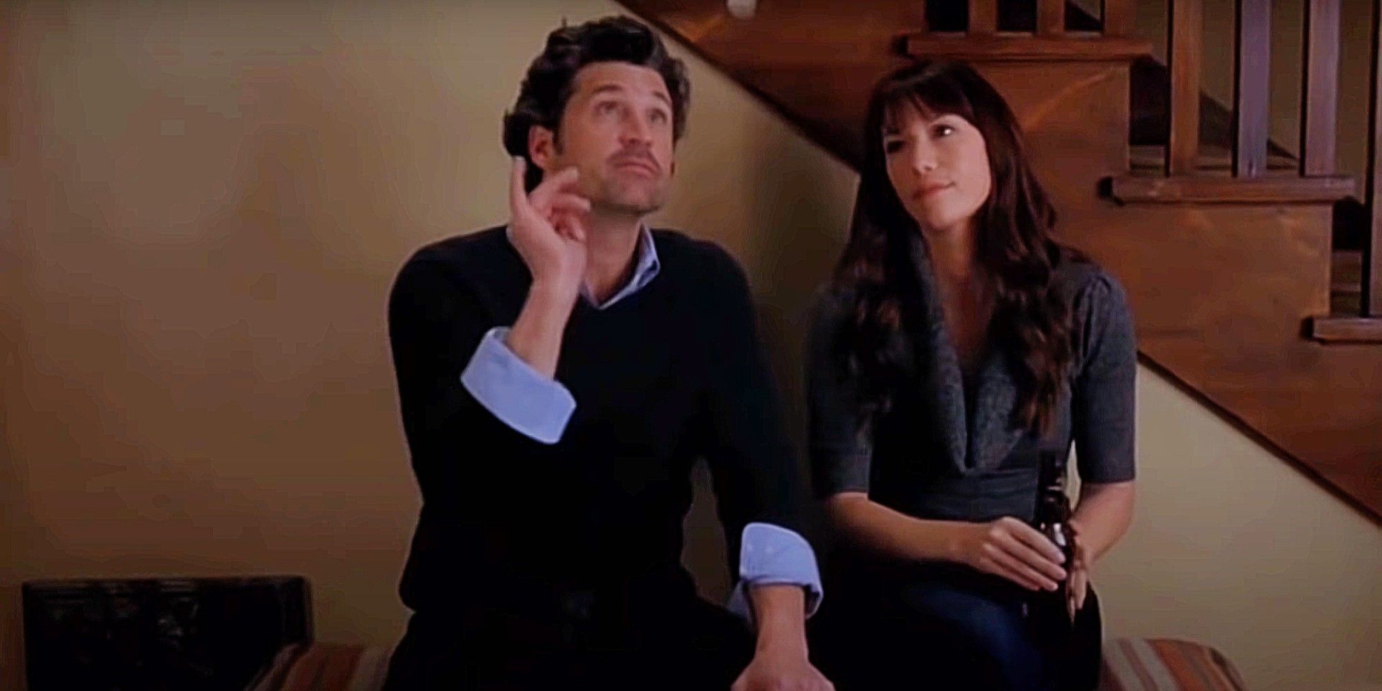 Derek Shepherd and Lexie Grey sitting next to each other at Meredith's house in Grey's Anatomy Season 8.