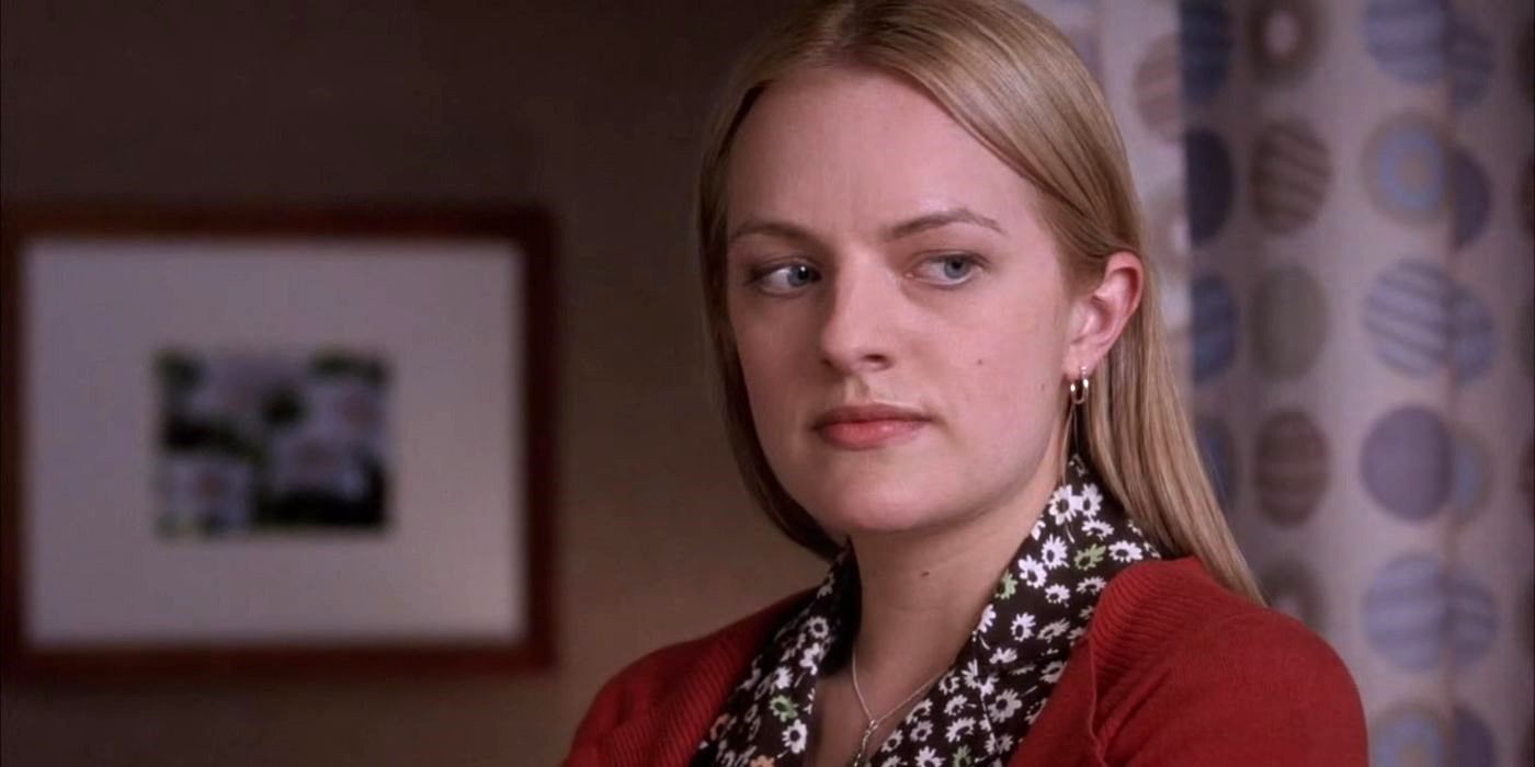 Elisabeth Moss as Nina Rogerson looks at something off camera with a serious expression on Grey's Anatomy.