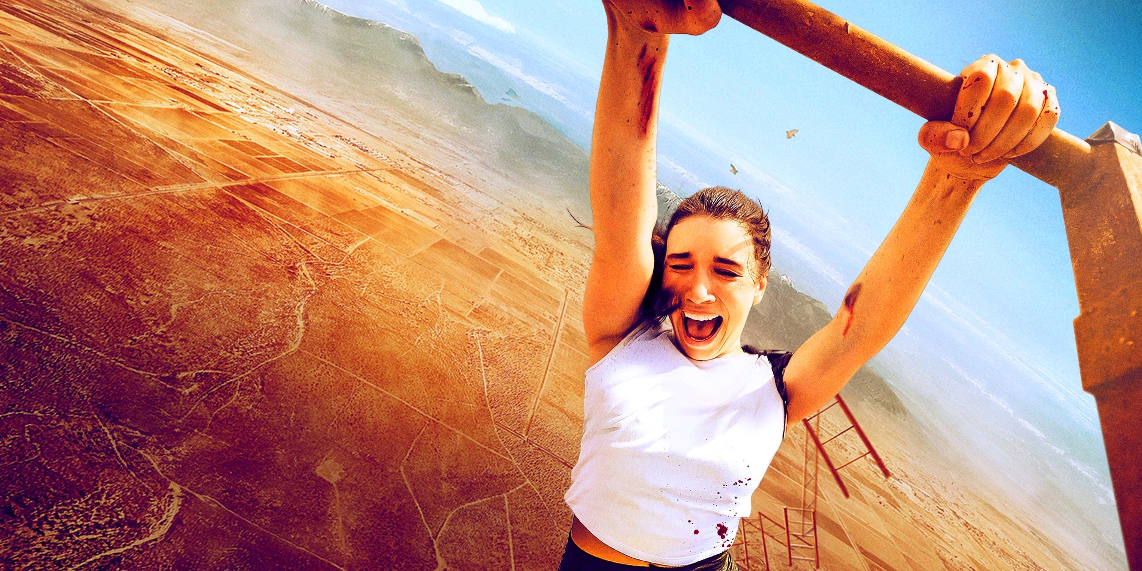 Becky, played by Grace Caroline Currey, screams as she hangs from a tower above the desert.