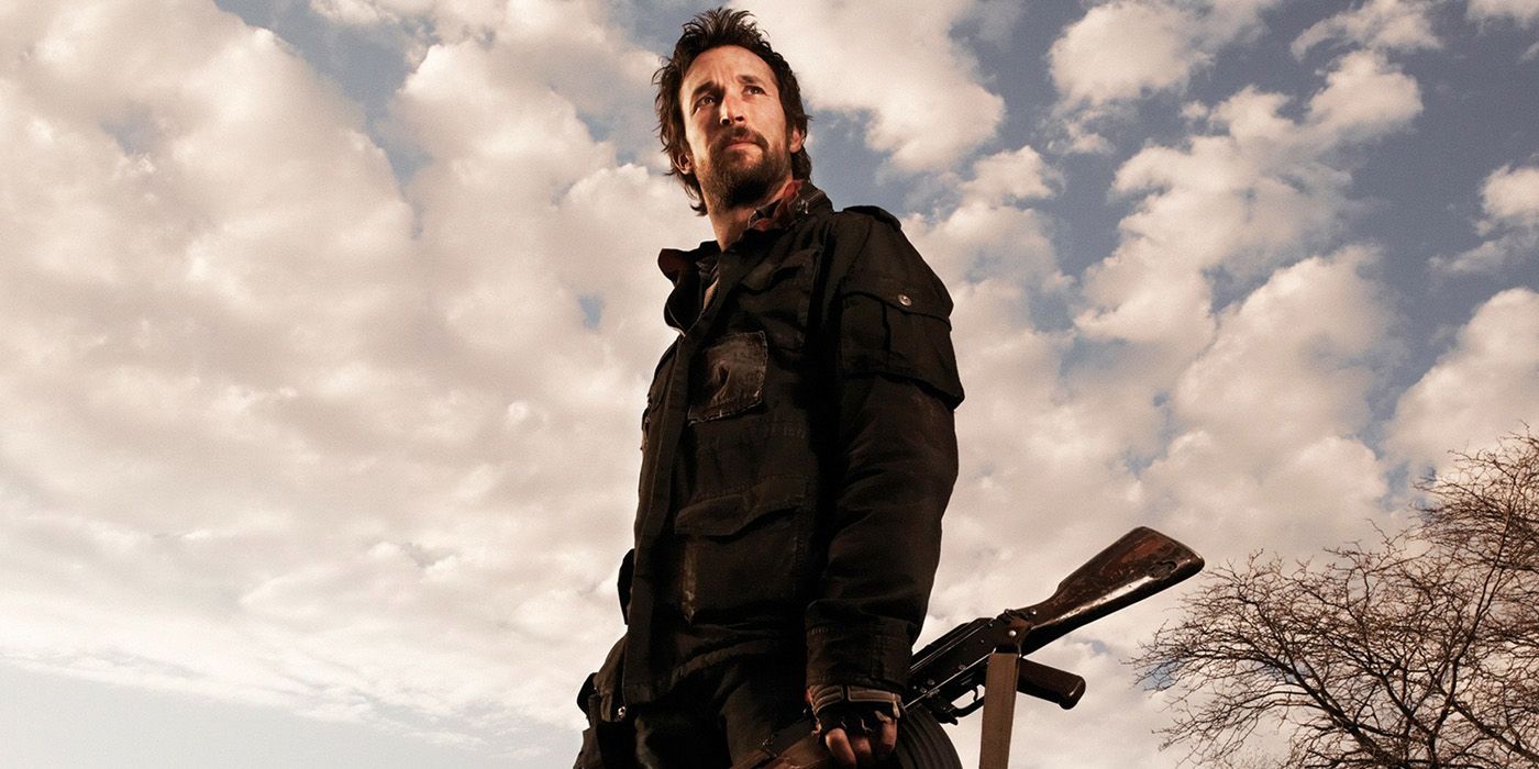 Noah Wyle as Tom Mason standing against a cloudy sky on 'Falling Skies'