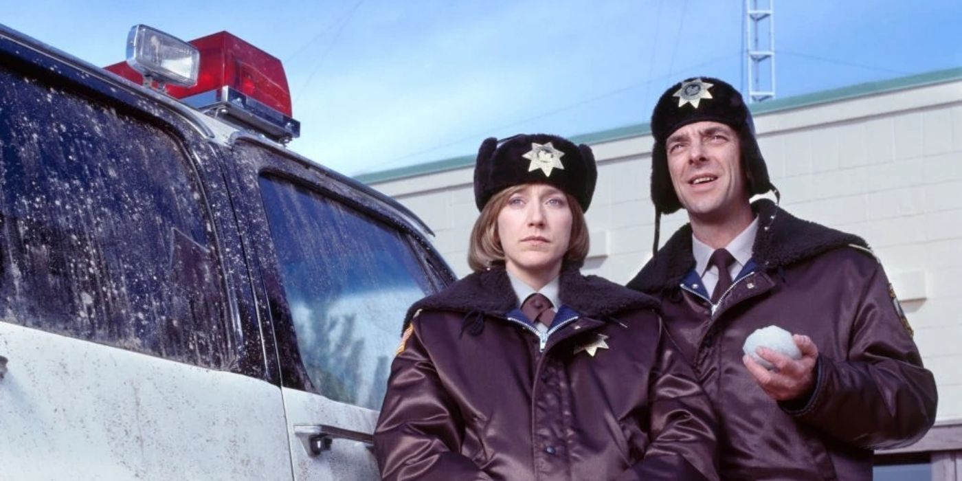 Edie Falco and Bruce Bohne standing near a police vehicle in the 2003 'Fargo' TV movie